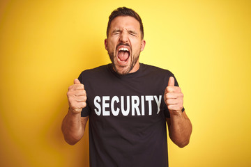 Young safeguard man wearing security uniform over yellow isolated background excited for success with arms raised and eyes closed celebrating victory smiling. Winner concept. - Powered by Adobe