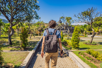 Young man tourist in budhist temple Brahma Vihara Arama Banjar Bali, Indonesia