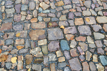 Old pavement of stones of different colors and sizes