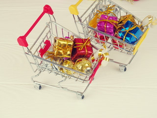 a cart full with gifts, the conception of Christmas gifts and shopping, the concept of online shopping