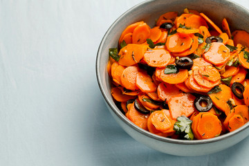 Traditional Moroccan cooked carrot salad North African vegan dish with chopped parsley and olives...