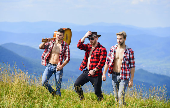 love is music. men with guitar in checkered shirt. western camping. campfire songs. happy men friends with guitar. friendship. hiking adventure. cowboy men. group of people spend free time together
