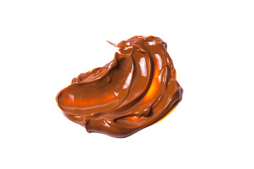Melted tasty caramel splashes isolated on white background.