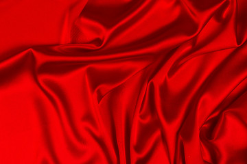 Obraz premium Red silk or satin luxury fabric texture can use as abstract background. Top view.