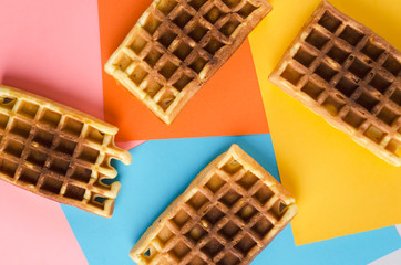 Top view of sweet waffles on the colorful background