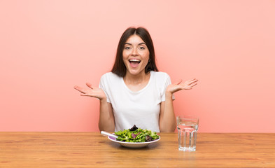 Young woman with a salad with shocked facial expression