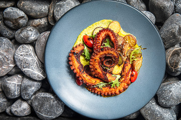 Delicious and exotic octopus dish with vegetables and sauce