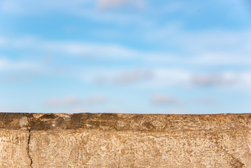 The old cement bridge close-up with the sky as a background