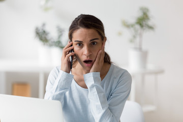 Head shot close up shocked woman listening to unbelievable news.