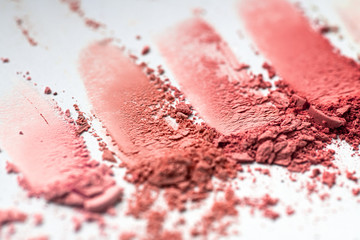 Crumbled blushes in different colors texture close-up, cosmetic pigments