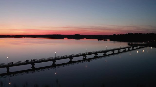 Flight by drone over the bridge of Lake Sirvena. The wooden pedestrian bridge, the longest in Lithuania, over the artificial lake Sirvena near Birzai.