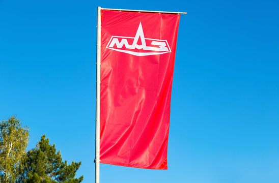 Dealership Flag Minsk Automobile Plant (MAZ) Over Blue Sky