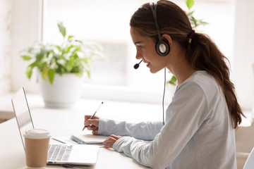 Concentrated millennial mixed race woman listening educational webinar.