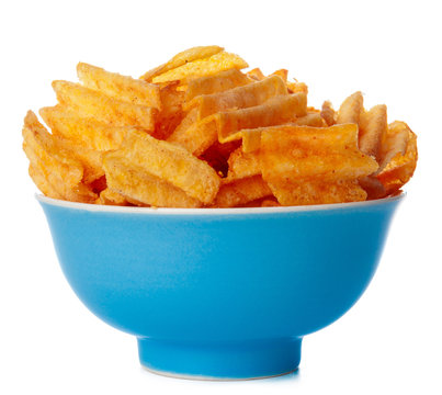 Bowl of ribbed potato chips isolated on white