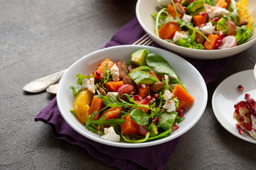 Tasty salad with avocado and baked pumpkin