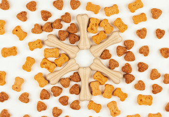  Dog treats in the form of hearts and bones on a white background.
