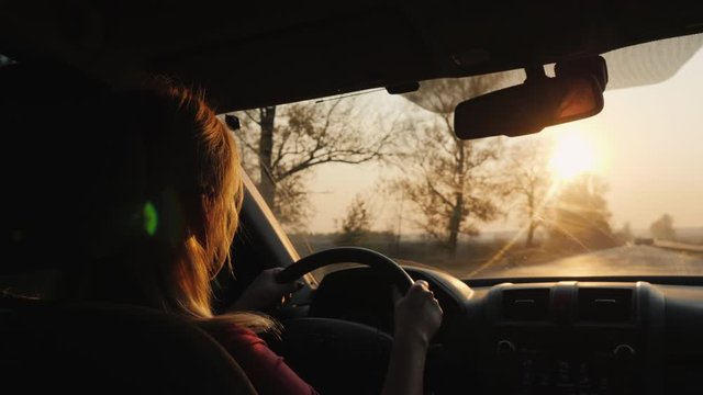 Silhouette of a female driver driving a car