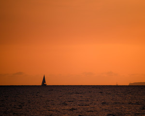 silhouette of sail ship in sunset