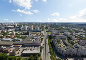 Summer city, road with cars and industrial zone, aerial view. Ekaterinburg, Verkh-Isetsky district, Russia