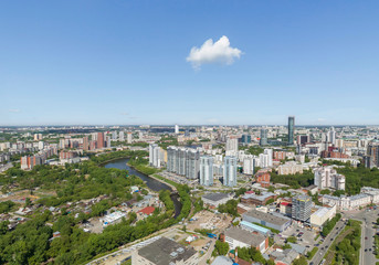 Obraz premium Summer city, road with cars and Iset river, a lot of trees, aerial view. Ekaterinburg, Verkh-Isetsky district, Russia