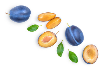 fresh blue plum and half with leaves isolated on white background. Top view. Flat lay