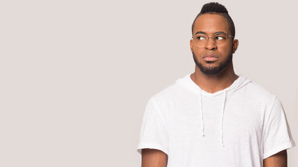 Serious african American man look at blank copy space