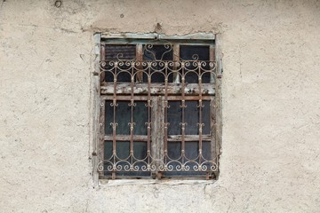 Fototapeta na wymiar Window of an abandoned adobe house