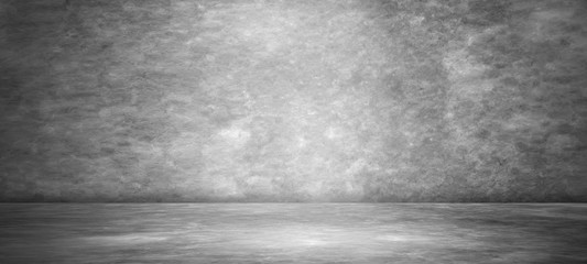 Gray cement wall texture for studio gradient room background, dark color wall surface used for background and display your products.