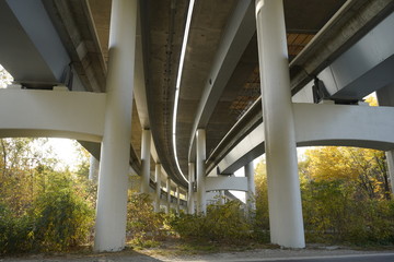 Unfinished bridge against the background of the silhouette of the city. Unfinished highway away city. Fender on the autobahn
