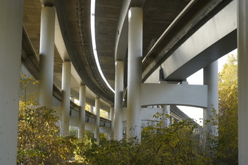 Obraz premium Unfinished bridge against the background of the silhouette of the city. Unfinished highway away city. Fender on the autobahn