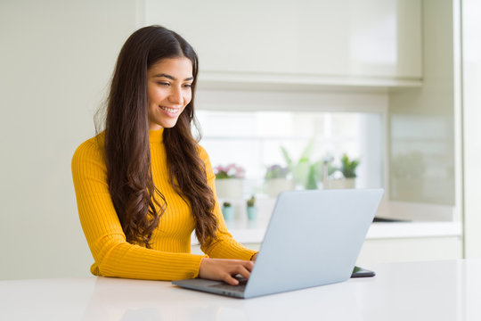 Beauitul young woman working using computer laptop concentrated and smiling