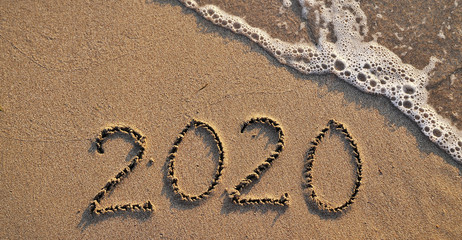 The symbols 2020 written on sand. New year concept.