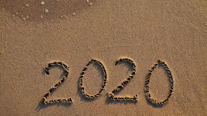 The symbols 2020 written on sand. New year concept.