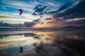Lonely raider kitesurfing on Los Lances beach at sunset, Tarifa, Cadiz province, Andalusia, Spain