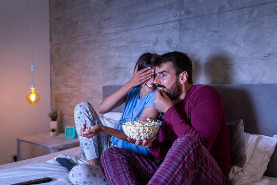 Couple In Bed Watching Scary Movie