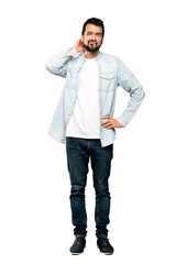 Fototapeta premium Full-length shot of Handsome man with beard having doubts over isolated white background