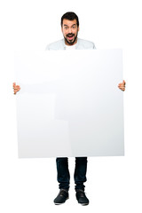 Handsome man with beard  holding an empty placard