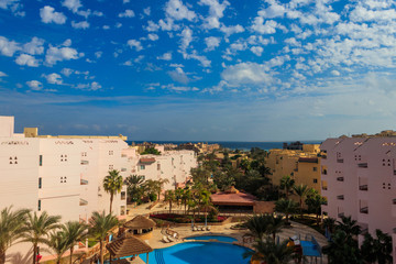 View of the luxurious hotel with a swimming pool and Red sea