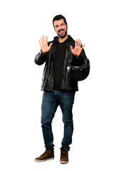 Full-length shot of Biker man counting ten with fingers over isolated white background