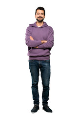Full-length shot of Handsome man with sweatshirt keeping the arms crossed in frontal position over...
