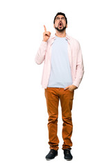Fototapeta premium Full-length shot of Handsome man with beard pointing up and surprised over isolated white background