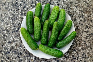 A stack of several fresh green cucumber gherkins in a plate, Sofia, Bulgaria   