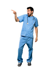 Full-length shot of Surgeon doctor man pointing away over isolated white background