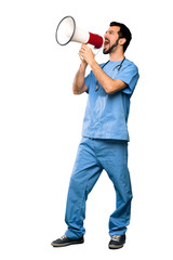 Full-length shot of Surgeon doctor man shouting through a megaphone over isolated white background