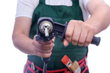 Man in coverall holding drill machine isolated on white