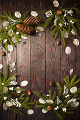 Christmas fir branches and decorations on dark wooden background
