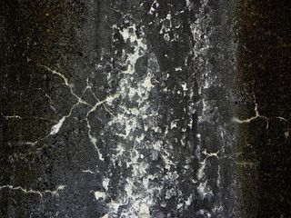 black wall with cracked paint