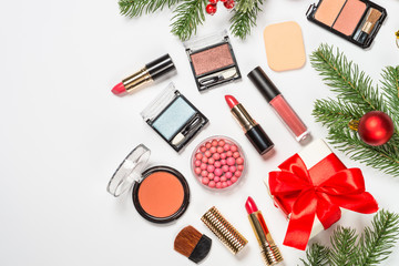 Makeup professional cosmetics on white with christmas decor.