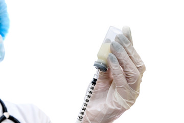 Nurse with syringe getting ready for injection
