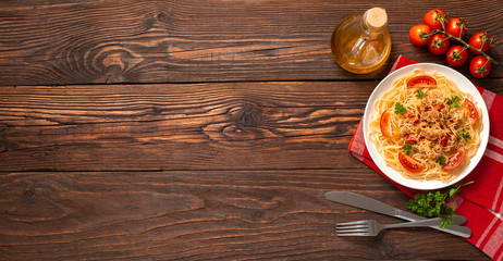 Pasta bolognese with tomato sauce and minced meat, grated parmesan cheese and fresh parsley - homemade healthy italian pasta on rustic wooden background. Flat lay. Top view.